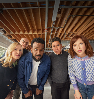 Seen from our viewers perspective, Wake Up with Craig Team (L-R: Angela, Creed, Craig, Oscar, Ellie) lean into camera as they are looking at Wake Up with Craig Clock.