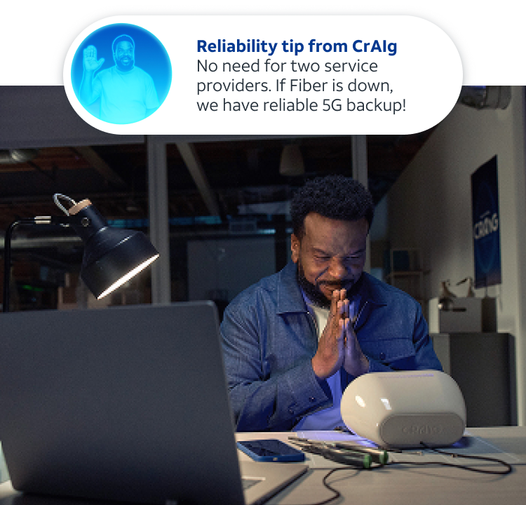 Craig at his desk with a basket of kittens, with a security alert showing on his laptop screen